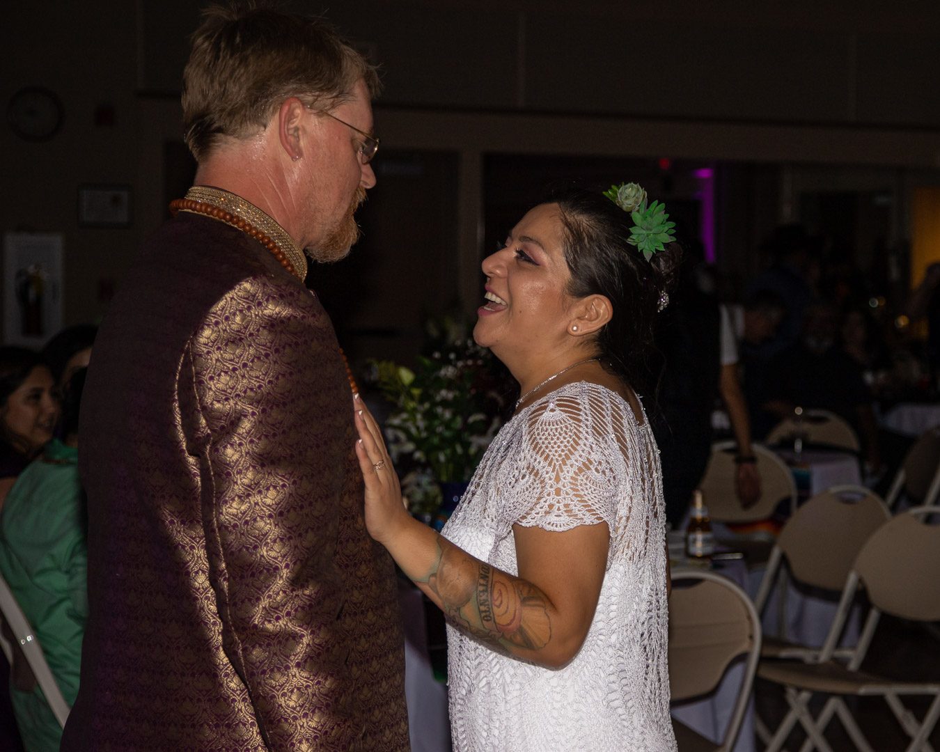 Bride laughing up at the groom on the dance floor