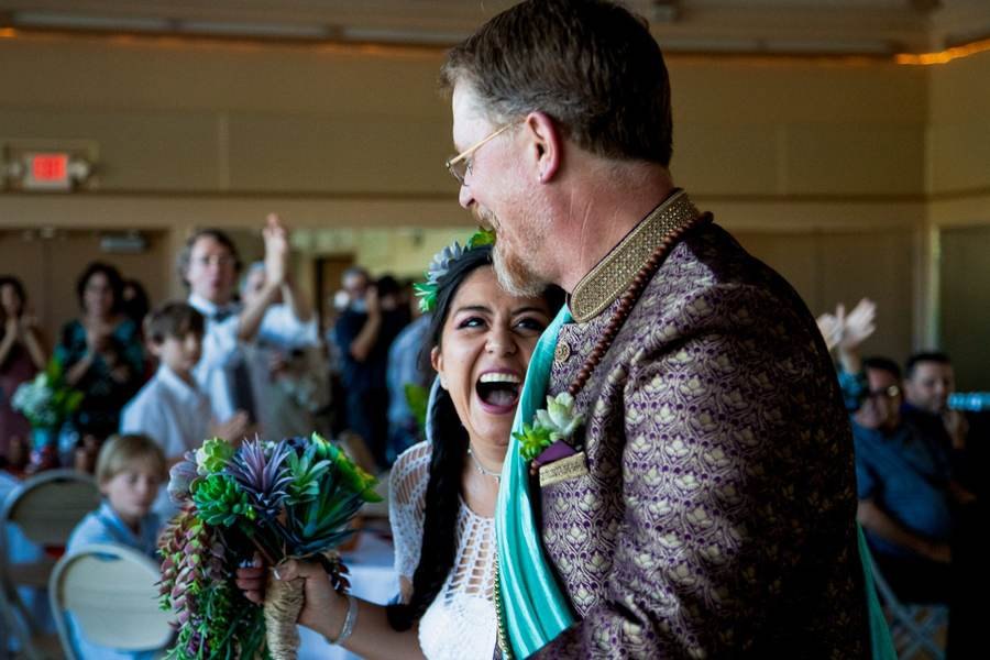 Crowd cheering for the newlyweds at their reception entrance