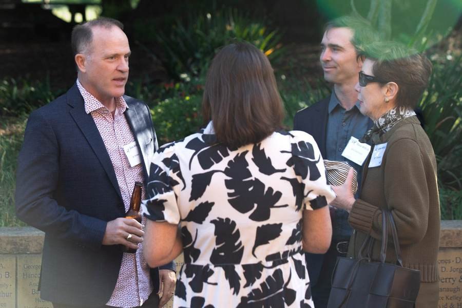 Guests mingling and talking at an outdoor reception