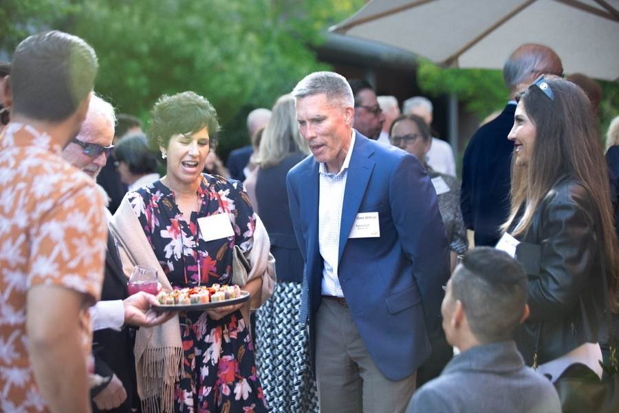Guests being served appetizers at an outdoor event